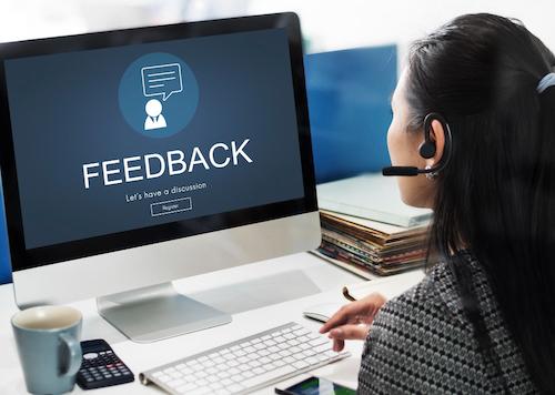 A computer monitor displaying a Feedback page that invites customers to leave online business reviews